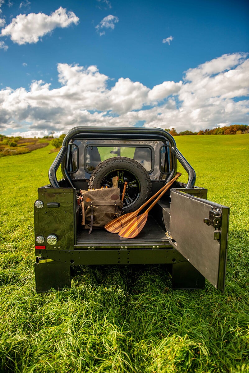 Land Rover Defender D110 Double Cab Bowler Bulldog: Exterior Truck back with open gate and paddles and pack