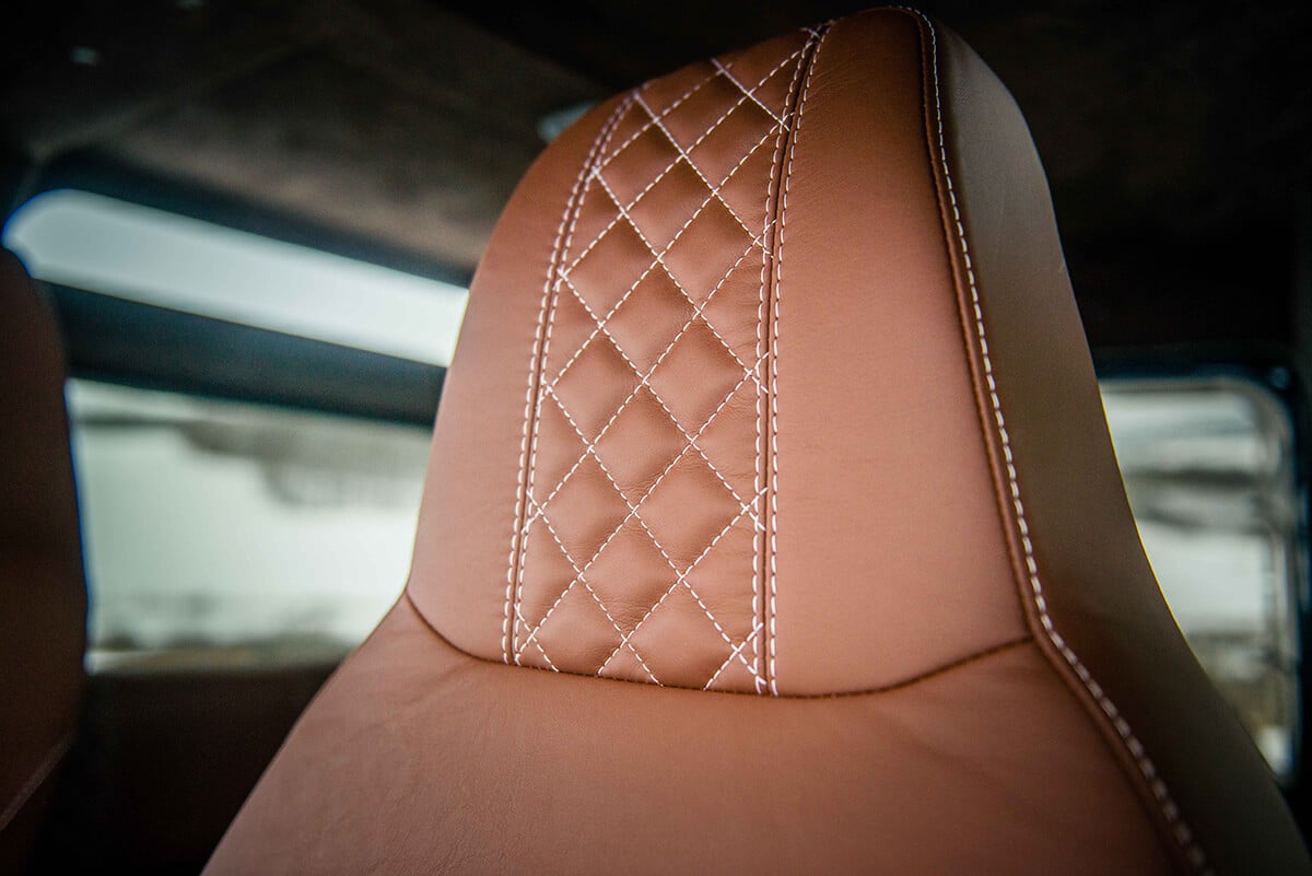 Land Rover Defender D90: Bespoke Leather Chestnut seat with contrast white stitch and quilted pattern