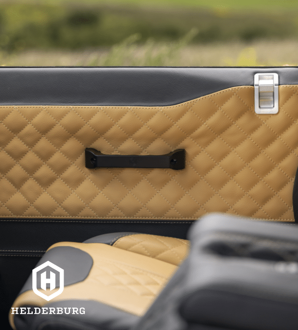 Restored Land Rover Defender 110 - leather and billet aluminum interior door details